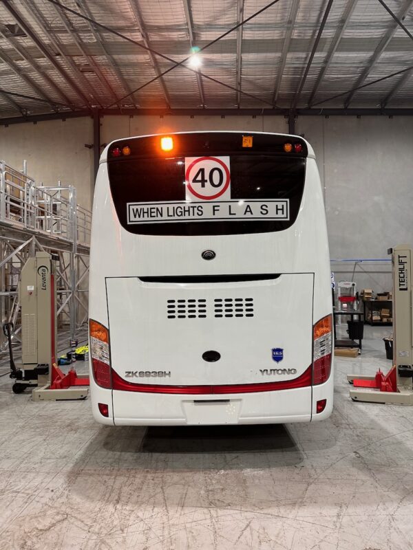Photo of the rear of a 2024 Yutong D9 bus with Safebus SB001A surface mount New South Wales TS150 school bus lights and signage installed