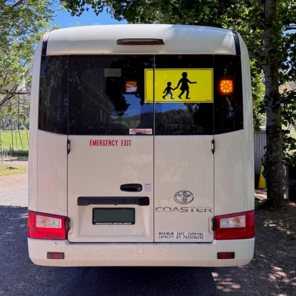 Photo of the rear of a 2024 4th generation B80 Toyota Coaster bus with Safebus SB001B window mount Victorian school bus lights and signage installed