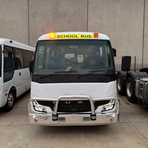 Photo of the front of a 2024 5th generation BE7 Mitsubishi Rosa bus with a Safebus Bullbar fitted and Victorian school bus lights and signage installed