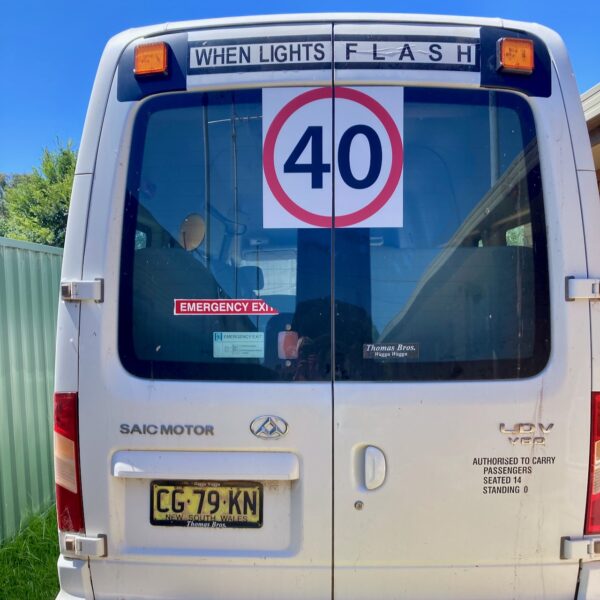 Photo of the rear of a LDV bus with Safebus SB001A surface mount school bus lights and NSW TS150 signage installed