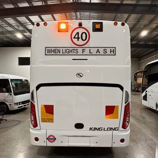 Photo of the rear of a King Long bus with Safebus SB001B window mount school bus lights and NSW TS150 signage installed