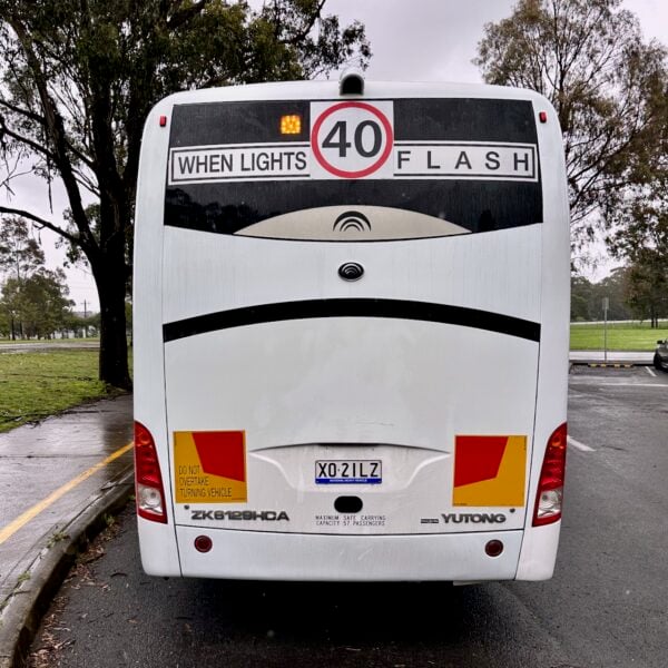 Photo of the rear of a Yutong D9 bus with Safebus SB001A surface mount school bus lights and NSW TS150 signage installed
