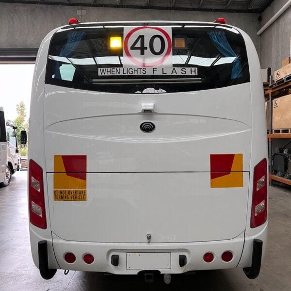 Photo of the rear of a Yutong D9 bus with Safebus SB001A surface mount school bus lights, NSW TS150 and Small When Lights Flash signage installed