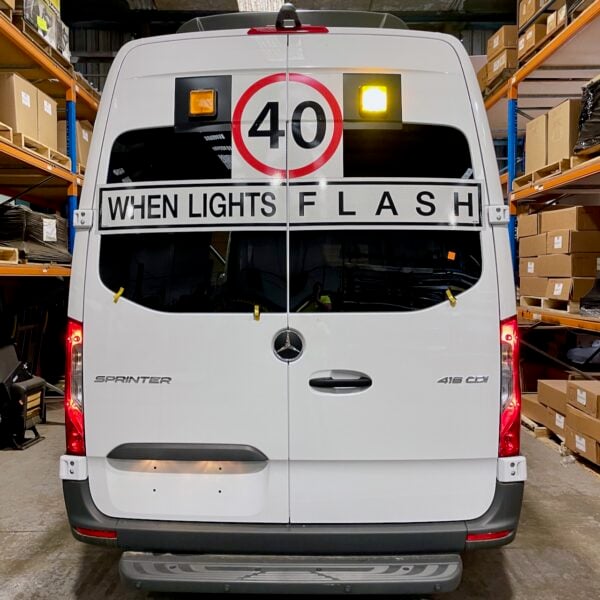 Photo of the rear of a 2024 Mercedes Sprinter bus with Safebus SB001A surface mount New South Wales TS150 school bus lights and signage installed