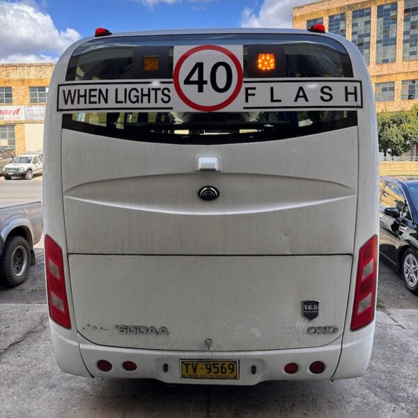 Photo of the rear of a Yutong bus with Safebus SB001B window mount school bus wig-wag lights and NSW TS150 signage installed