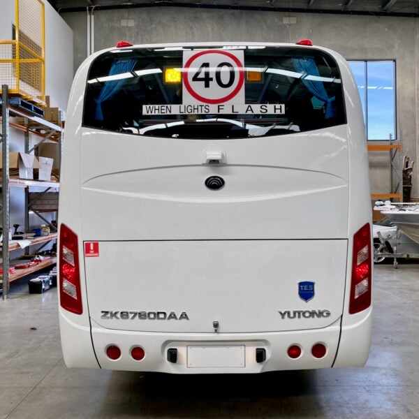 Photo of the rear of a Yutong D9 bus with Safebus SB001A surface mount school bus lights and NSW TS150 and Small When Lights Flash signage installed