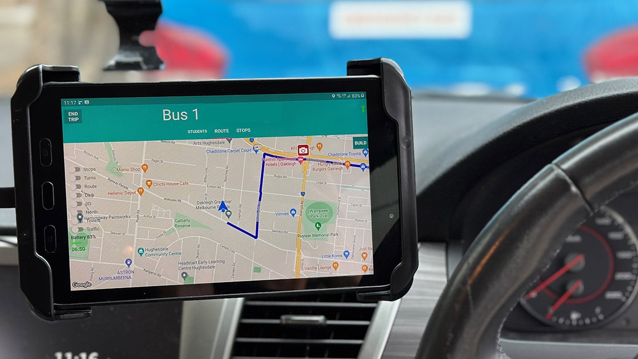 Photo of tablet running Busminder bus and student tracking software. The tablet is installed on the dash of a small school bus