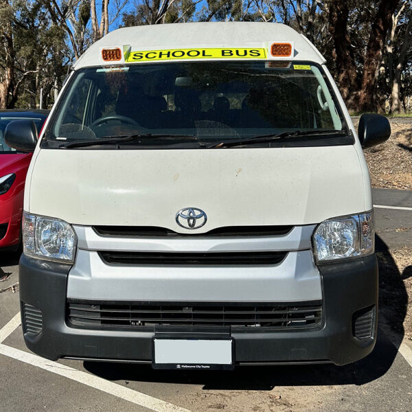 Photo of the front of a 2004 5th generation Toyota HiAce Commuter bus with exterior mount Victorian school bus lights and signage installed