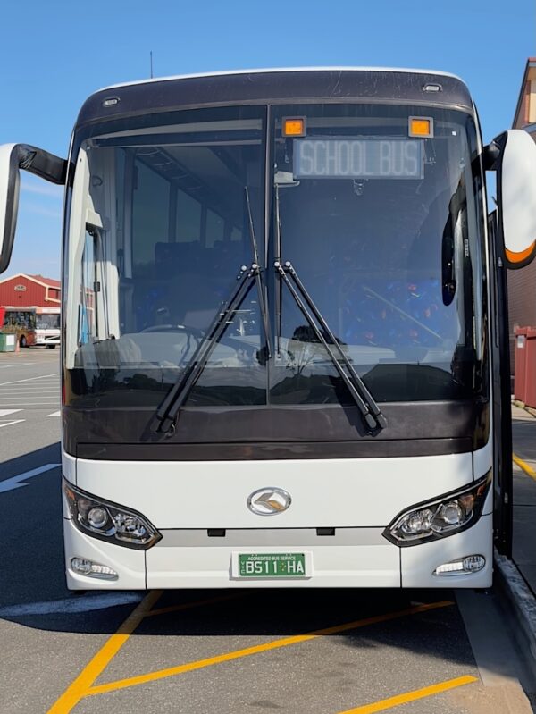 Photo of the front of a 57 seater King Long bus with Safebus SB001B window mount school bus lights and South Australian signage installed