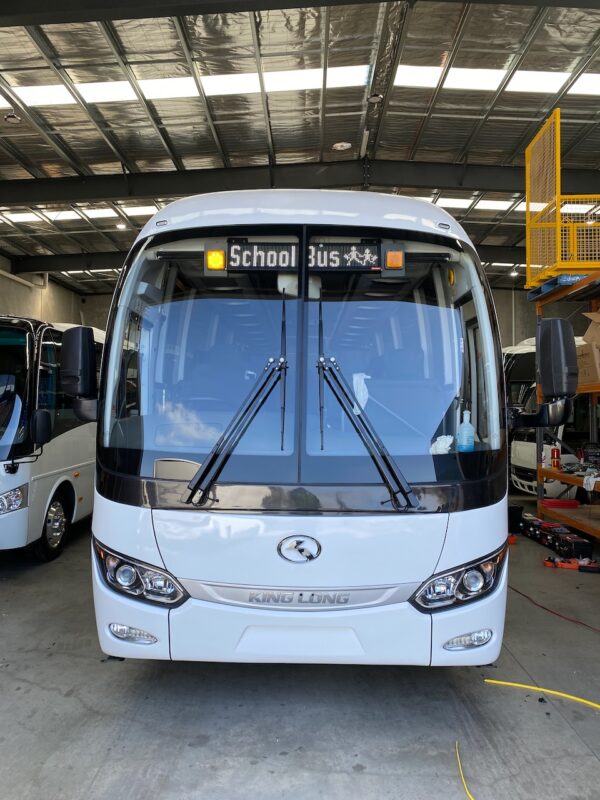 Photo of the front of a 57 seater King Long bus with Safebus SB001B window mount school bus lights and Victoria signage installed